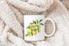 a white coffee mug with a picture of lemons on it