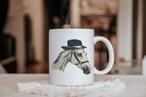 a white coffee mug with a picture of a horse wearing a hat