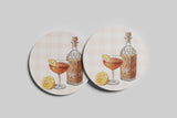 a bottle of liquor and a glass of wine, along with a lemon slice, all set against a checkered background.