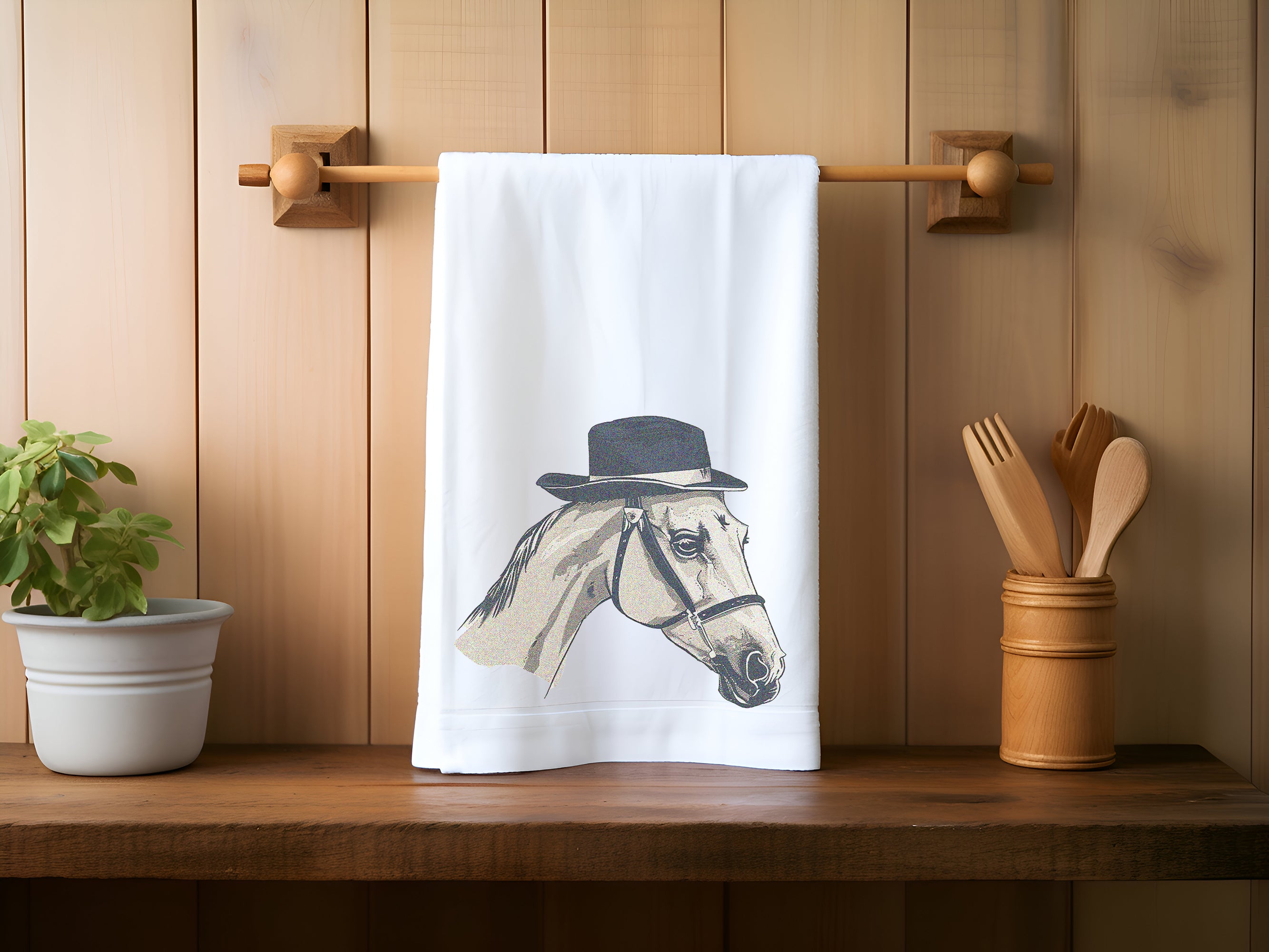 a tea towel with a horse wearing a top hat