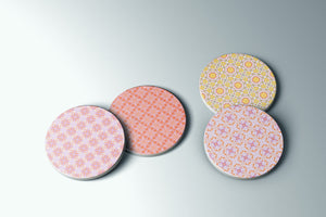 a group of four coasters sitting on top of a table