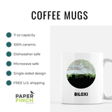 a coffee mug with a picture of a city on it