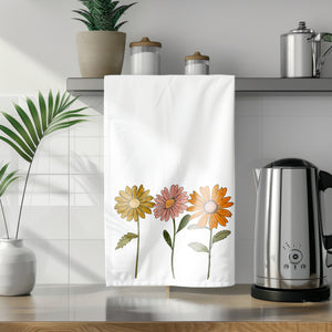 a towel hanging on a kitchen counter next to a potted plant