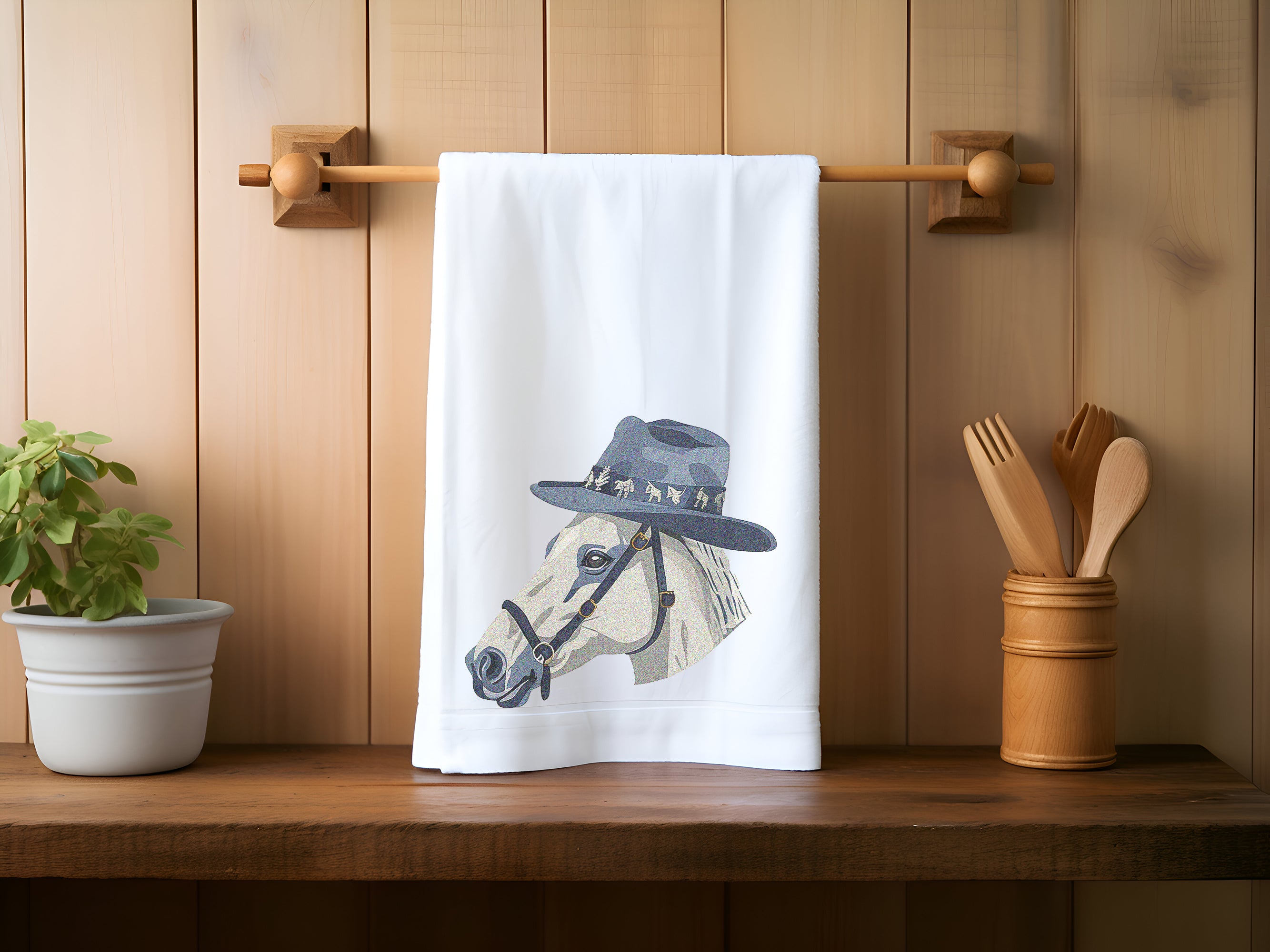 a tea towel with a picture of a horse wearing a hat