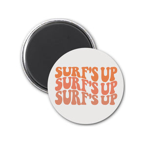 a round magnet with the words surf's up on it