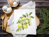 a picture of lemons on a napkin next to eggs