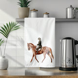 a tea towel with a picture of a man riding a horse