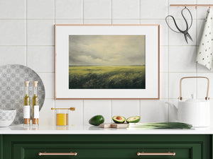 a kitchen with a green cabinet and a painting on the wall