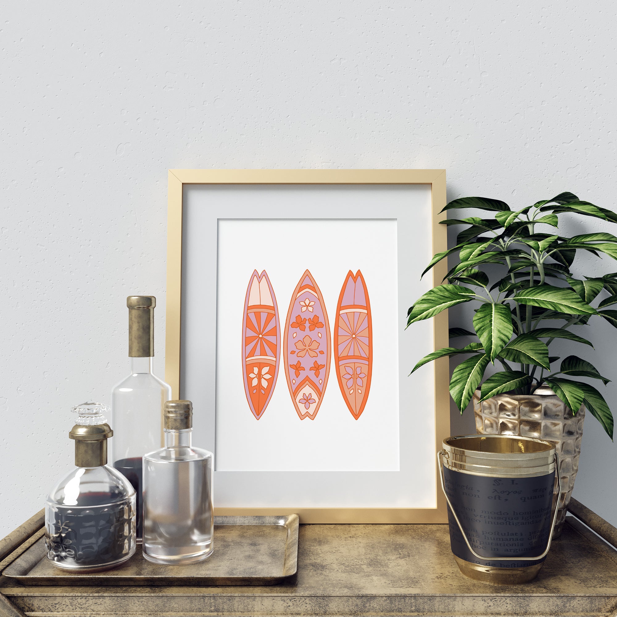 a picture of three surfboards on a table next to a potted plant