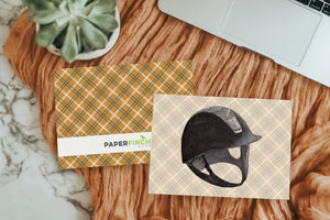 a picture of a helmet on a piece of paper next to a laptop