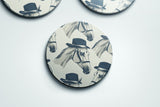 a set of three coasters with a horse wearing a top hat