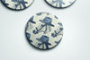 a set of three blue and white coasters with hats on them