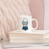 a coffee mug sitting on top of a book