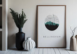 a framed poster of a city skyline with the word "Bellingham" written below it, placed on a wall next to a black vase and a white vase.