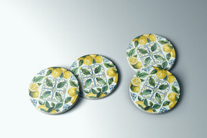 three plates with lemons and leaves painted on them