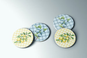 three plates with lemons and blueberries painted on them