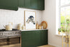 a kitchen with green cabinets and a white tiled wall