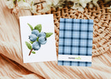 two cards with blue flowers on them next to a basket