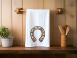 a towel hanging on a wooden wall next to a potted plant