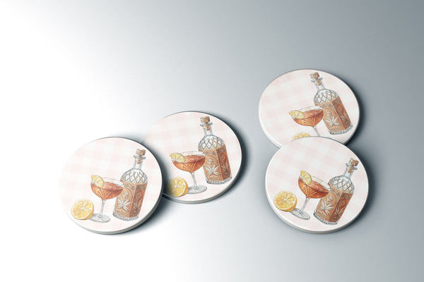 a collection of circular coasters with illustrations of cocktails and garnishes, such as lemon slices and bottles.