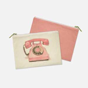 a pink phone pouch sitting next to a white bag