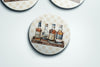 three coasters with bottles of liquor on them