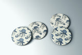 a set of four blue and white plates