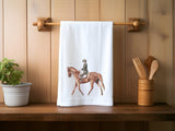 a tea towel with a picture of a man riding a horse