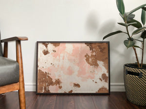 a picture frame sitting on top of a wooden floor next to a potted plant