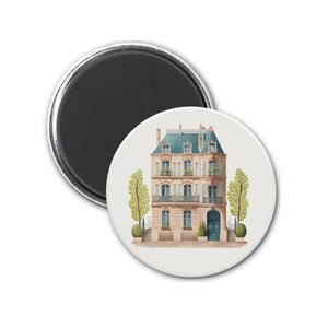 a round magnet with a drawing of a house on it