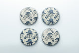 a set of four blue and white buttons with hats on them