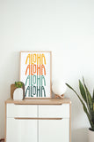 a white cabinet with a plant and a picture on top of it