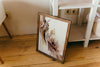 a picture frame sitting on a wooden floor