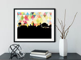 Auburn Alabama art print. Features the Auburn Alabama skyline and a geometric background. In yellow and shown in a black frame. Other colors and frame options available. Designed by Paperfinch.