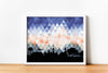 Auburn Alabama art print. Features the Auburn Alabama skyline and a geometric background. In blue and orange and shown in a white frame. Other colors and frame options available. Designed by Paperfinch.