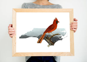 Northern cardinal art print on a North Carolina state silhouette. Giclee wall art with the North Carolina state bird. Designed by Paperfinch.