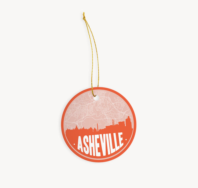 Asheville, North Carolina Christmas ornament in orange - featuring the Asheville skyline and an Asheville road map. By Paperfinch Design