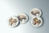 three coasters with a picture of a cow and a horse on them