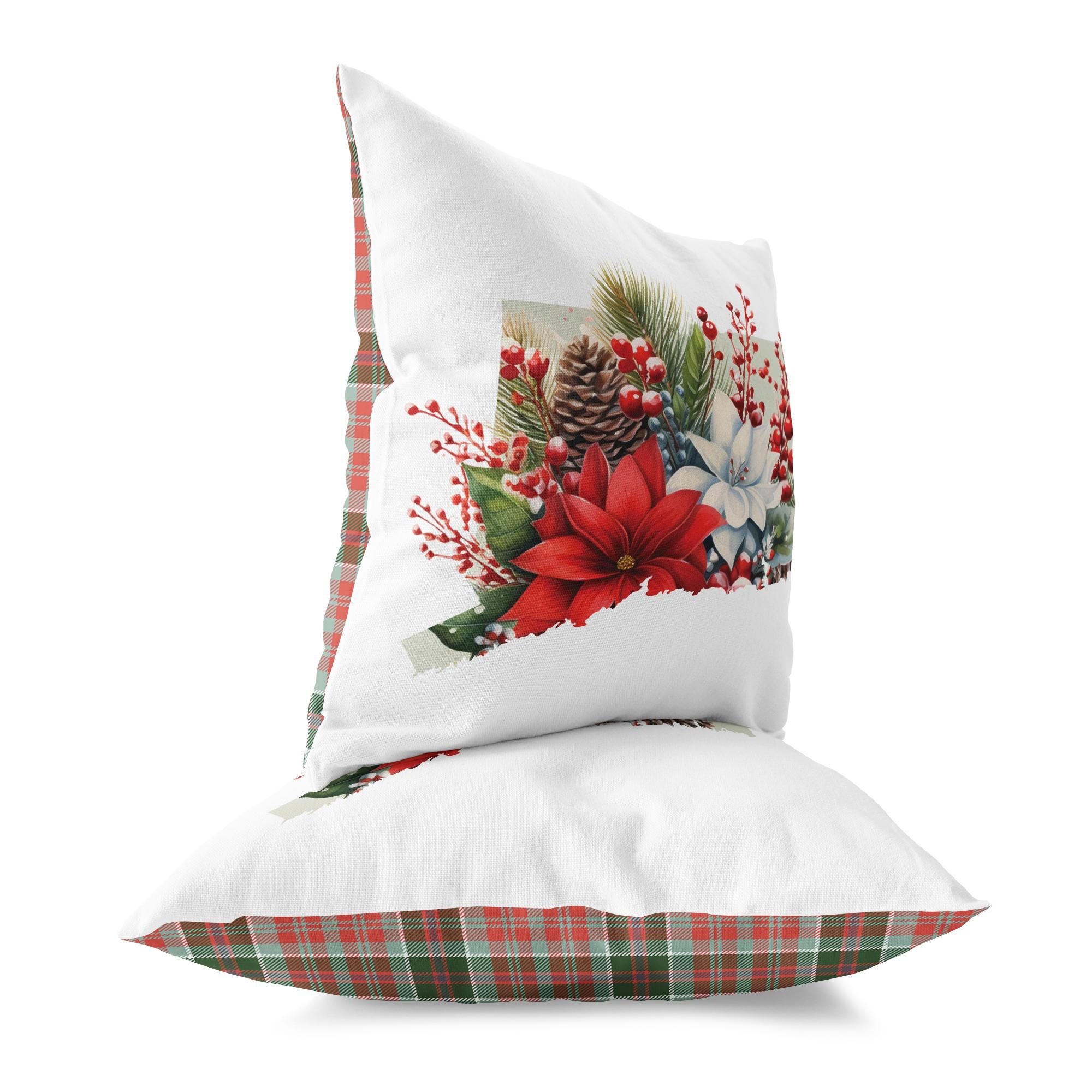 a white pillow with a red poinsettia and pine cones on it