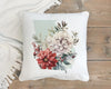 a white pillow with a floral painting on it