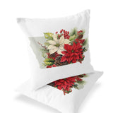 a white pillow with a picture of poinsettis and pine cones