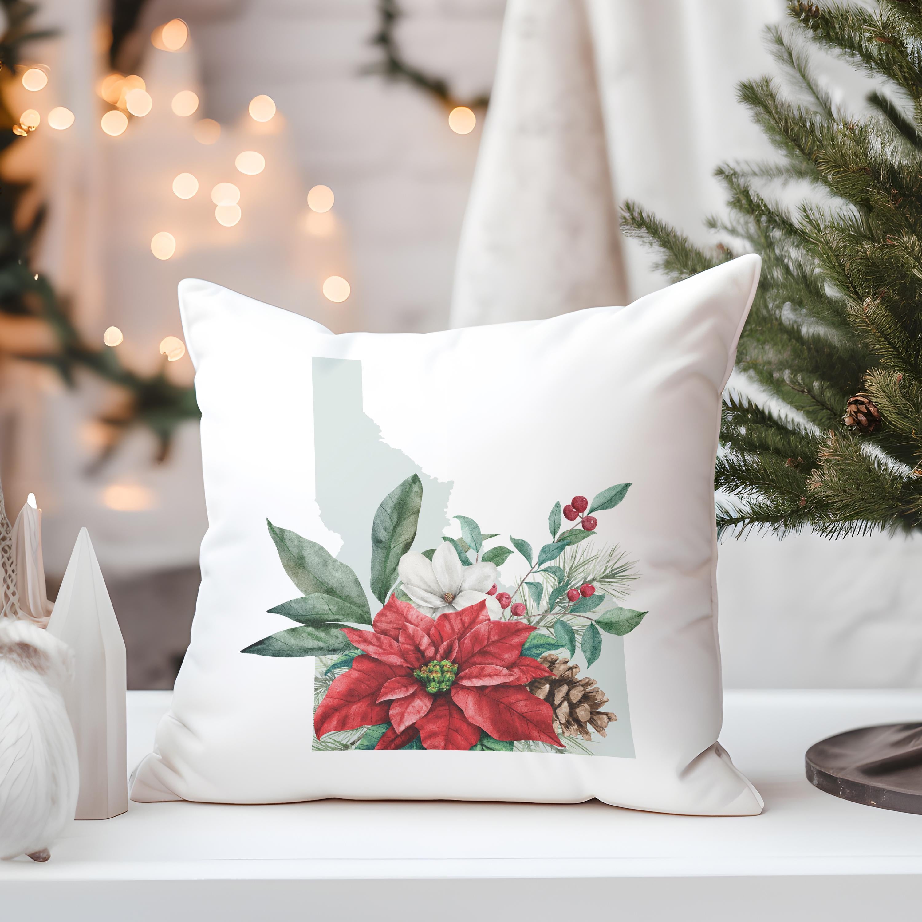 a white pillow sitting on top of a table next to a christmas tree