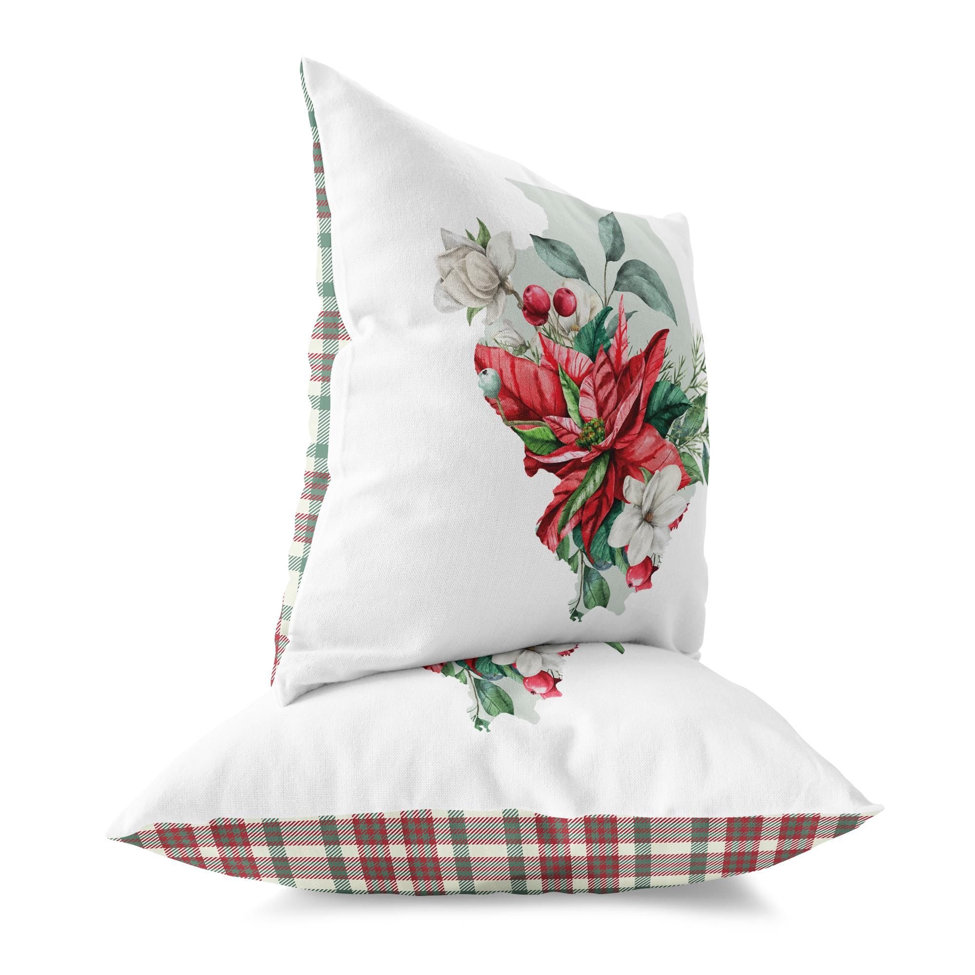 a white pillow with a red poinsettia on it