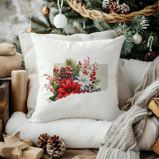 a christmas pillow sitting on top of a chair next to a christmas tree