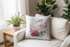 a white chair with a pillow on it next to a potted plant