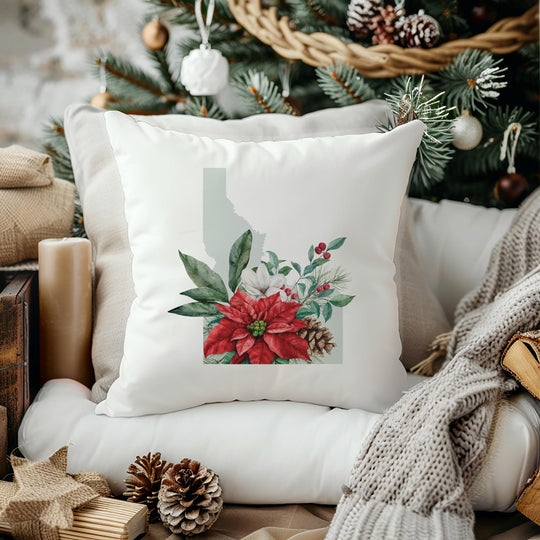 a white pillow sitting on top of a chair next to a christmas tree