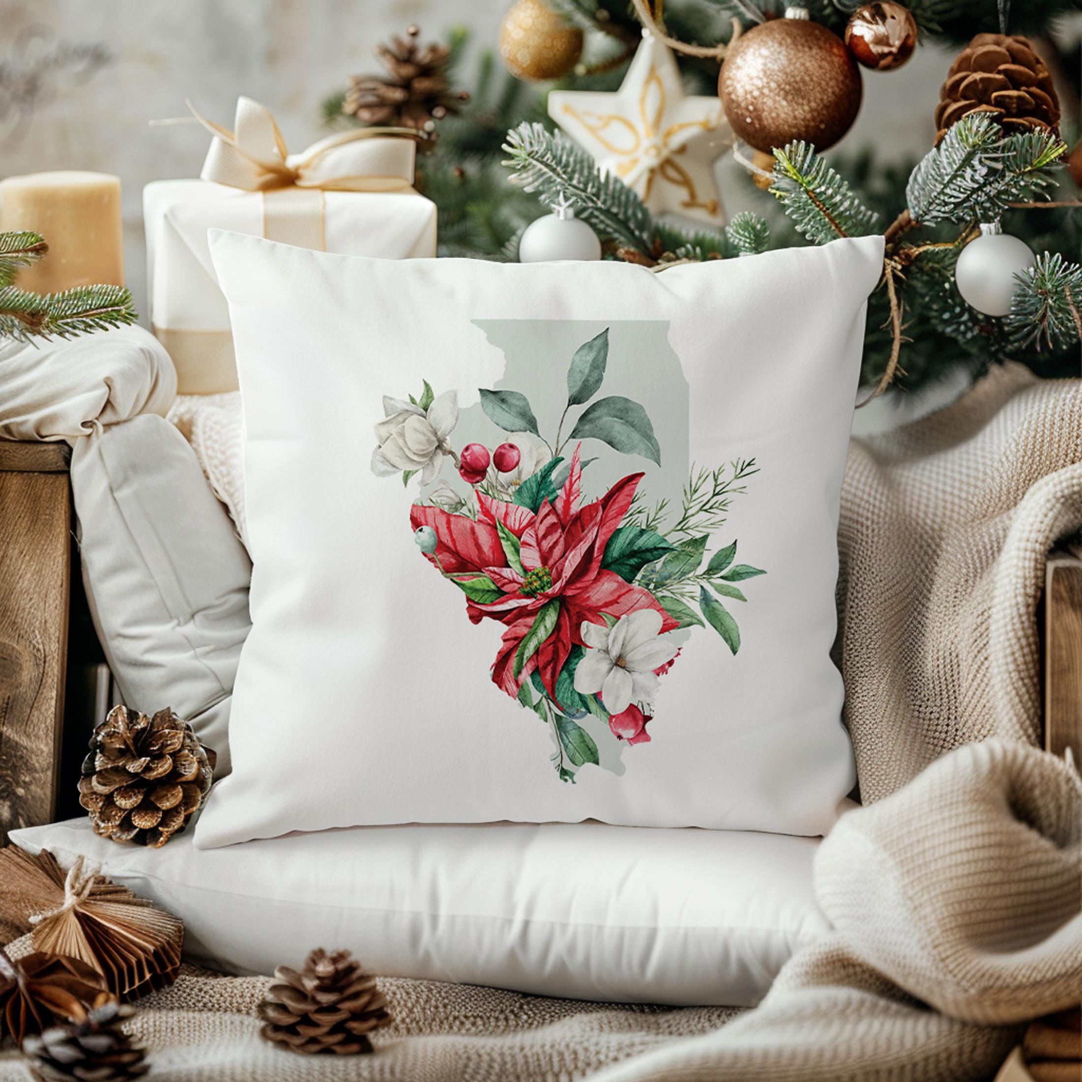 a white pillow sitting on top of a chair next to a christmas tree