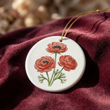 Close-up of a 3-inch Ranunculus Revival ornament with vintage floral illustration, gold accents, and intricate details on a velvet surface.